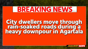 City dwellers move through rain-soaked roads during a heavy downpour in Agartala on May 26. |